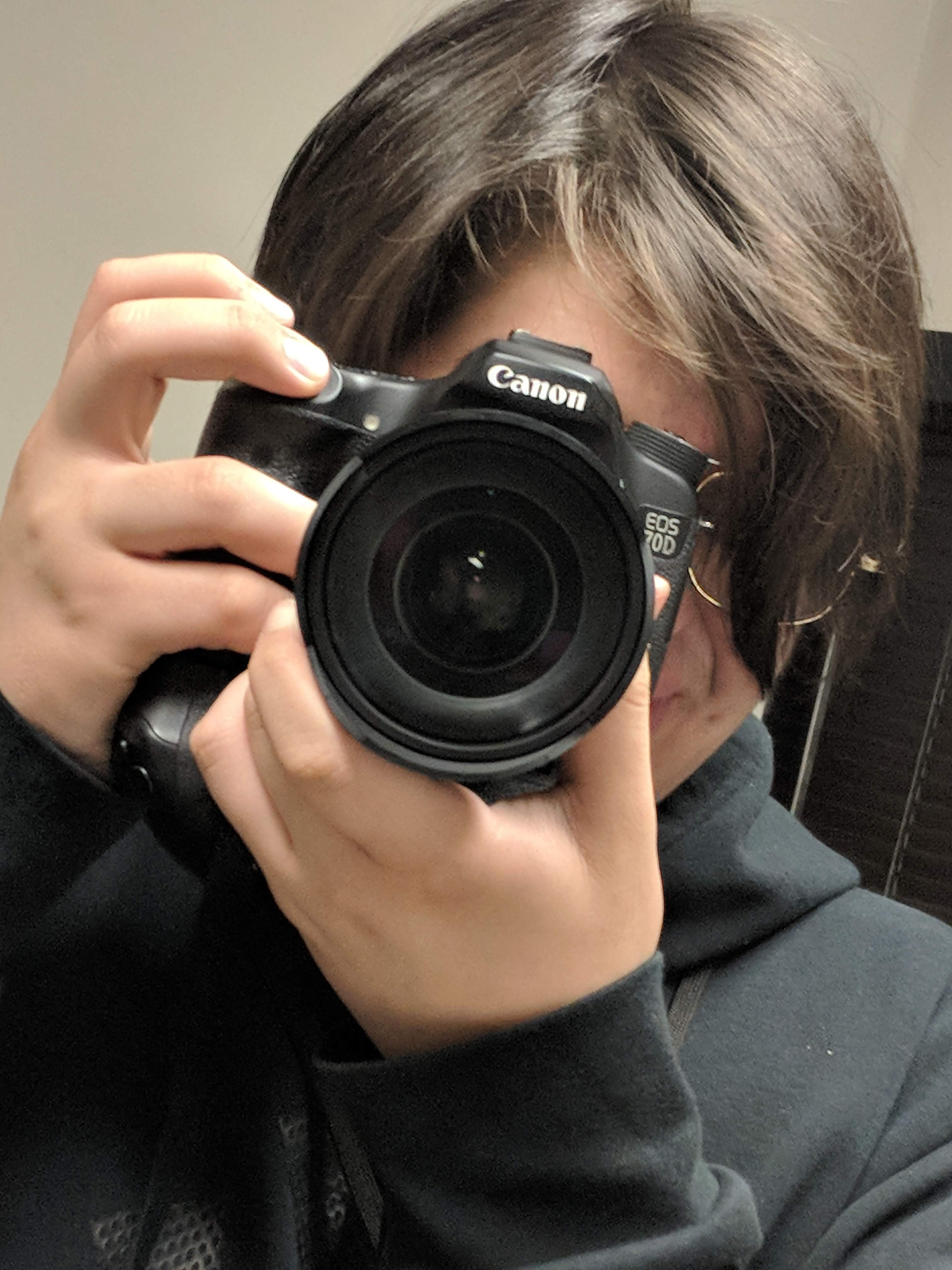 Scholar photographing with a Canon camera