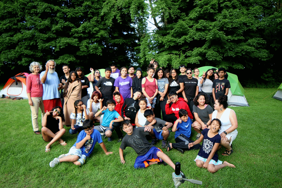 Latino Youth Collective scholars at a summer retreat, gathered together outdoors