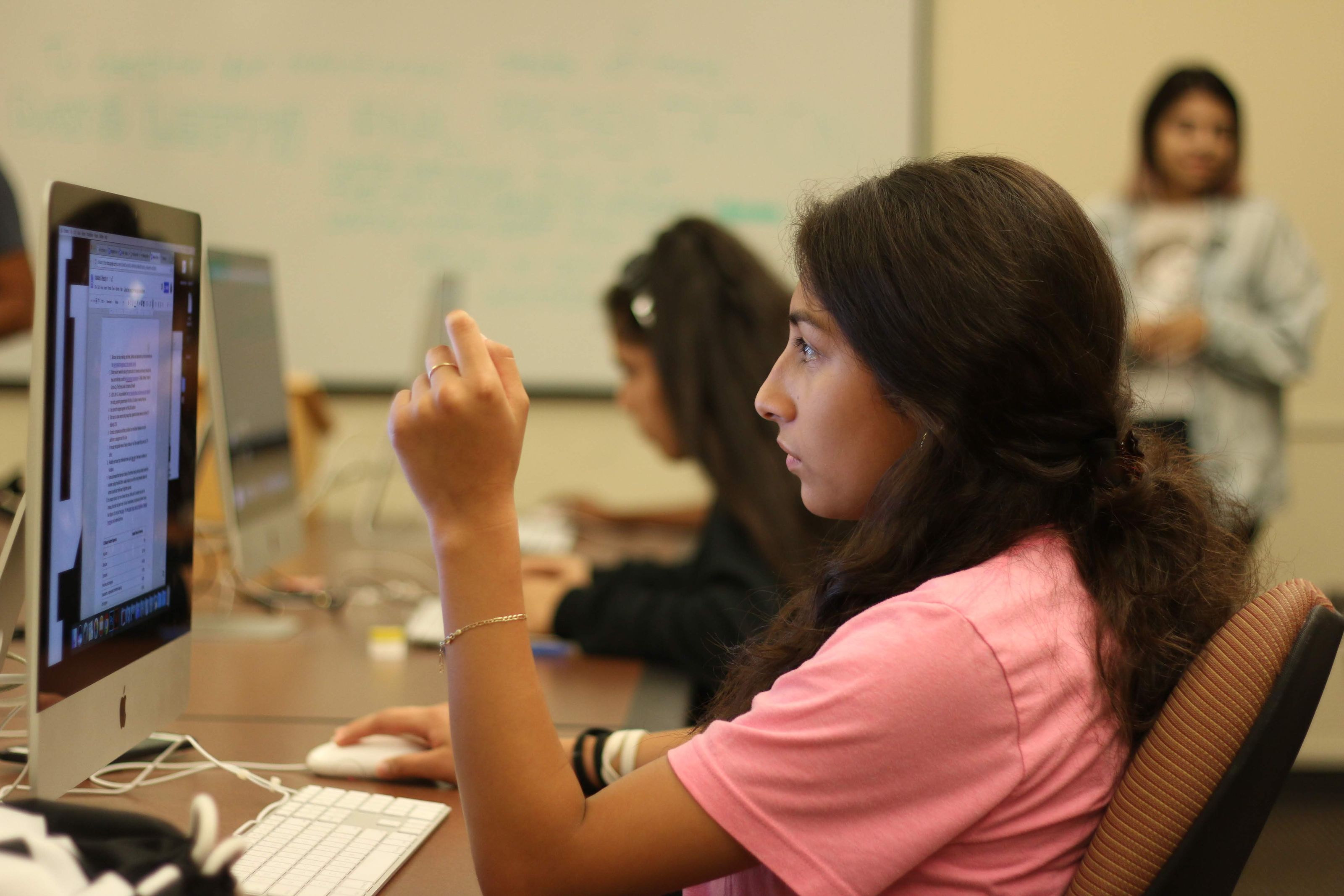 Scholar working at a computer during a Latino Youth Collective program