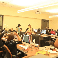 Scholars working together at computer stations during a Latino Youth Collective program
